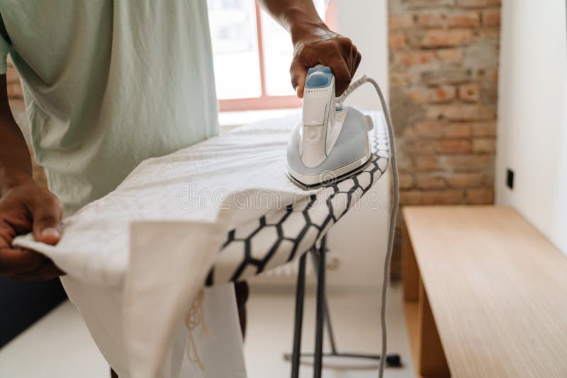 man ironing cloth